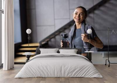 Portrait of sporty beautiful smiling woman in sportswear and white towel on neck  Wall mural